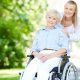 caregiver pushing senior woman wheelchair 1